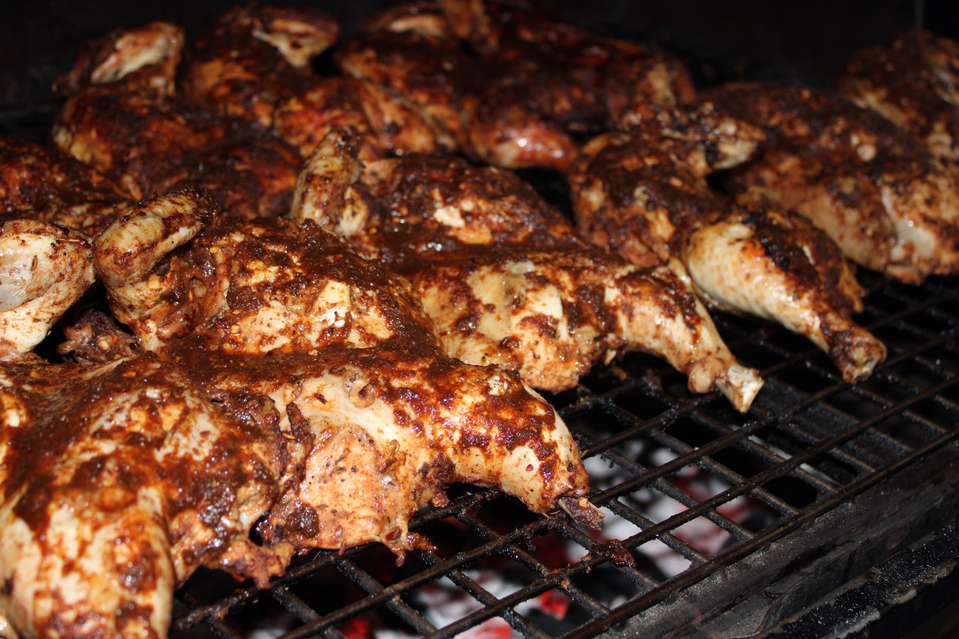 Jerk chicken cooking over the grill
